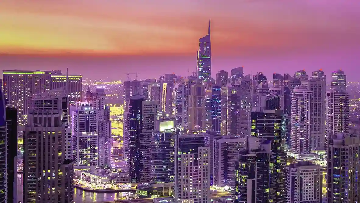 A vibrant cityscape of DMCC Dubai at dusk, showcasing the Dubai Multi Commodities Center and highlighting opportunities for company formation in Dubai. The image underscores DMCC's role as a central business hub with various companies, reflecting the dynamic commercial activities and opportunities for setting up companies in Dubai.